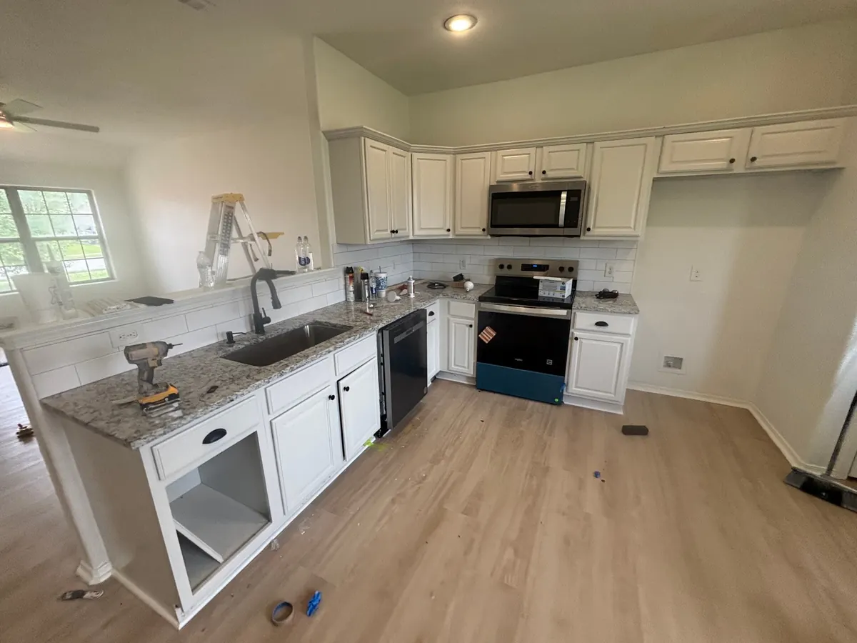 Kitchen remodel with white cabinets and new flooring