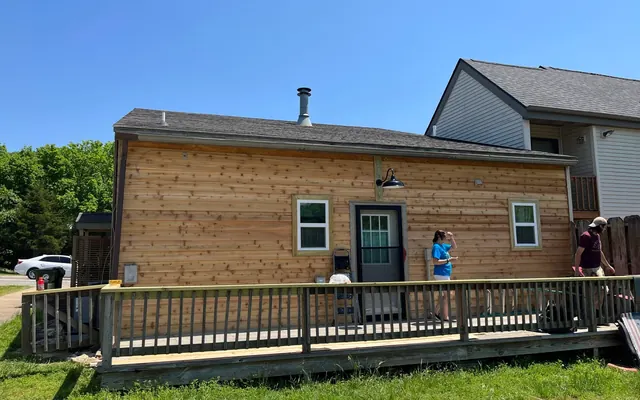 Cedar-sided home with a long new deck