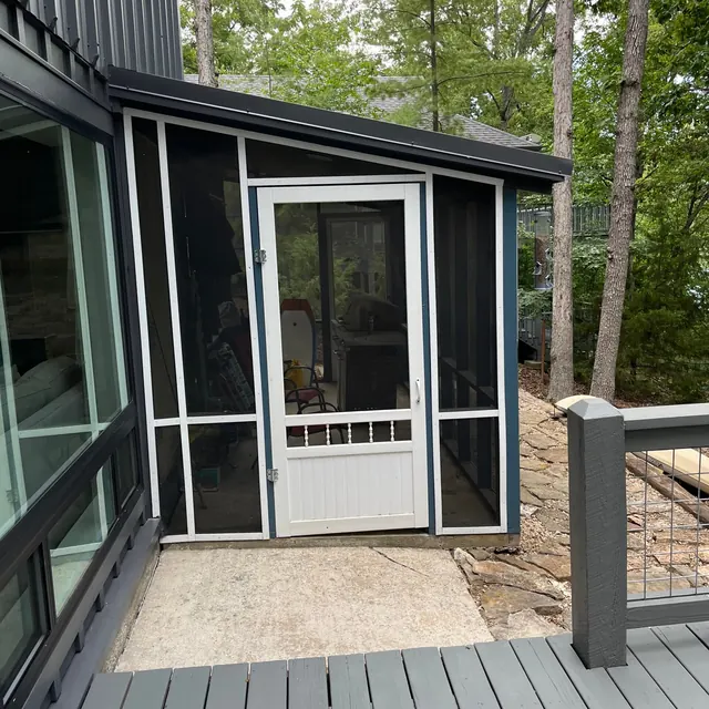 Screened porch with a new door and gray deck